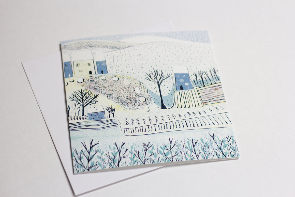 Blue Winter Christmas greeting card displayed with envelope
