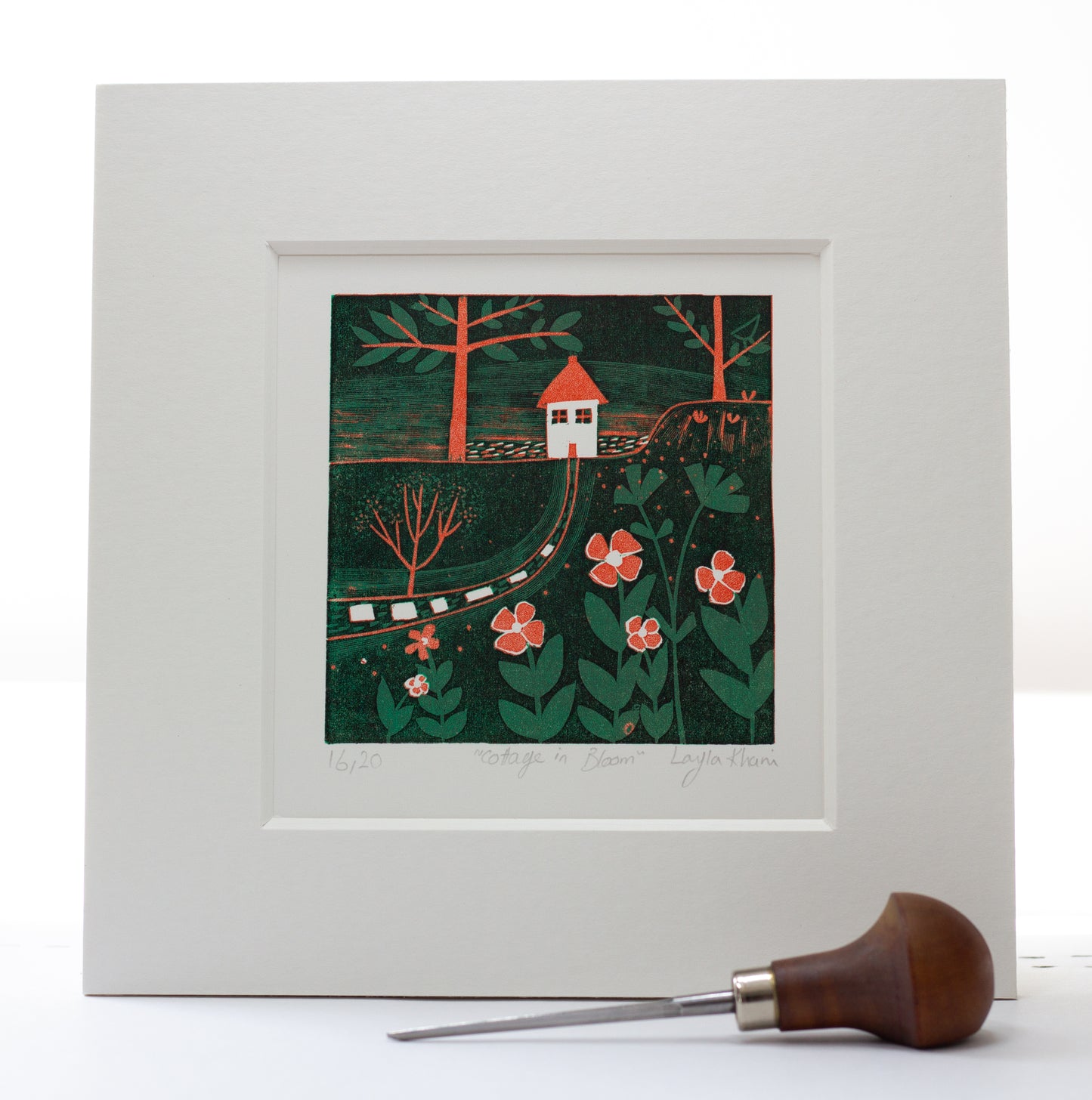 White-mounted mini linocut red house print, shown with a brayer printmaking tool