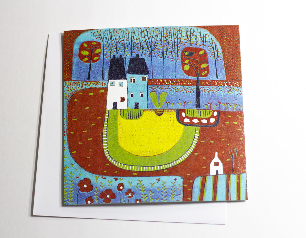 Over the Meadow square linocut greeting card displayed with an envelope
