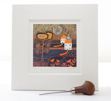 Load image into Gallery viewer, linocut print titled Evening Glow, showcasing a stylised landscape of cottages, trees, and flowers in bold orange and blue hues, with a radiant sun setting overhead.