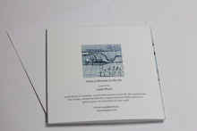 Load image into Gallery viewer,  "Back of a Christmas card from the Wintry Wonders Collection, featuring a minimalist design with a small logo and a brief description of the collection. The back includes a space for a personal message and a subtle snowflake motif, complementing the snowy scene on the front.
