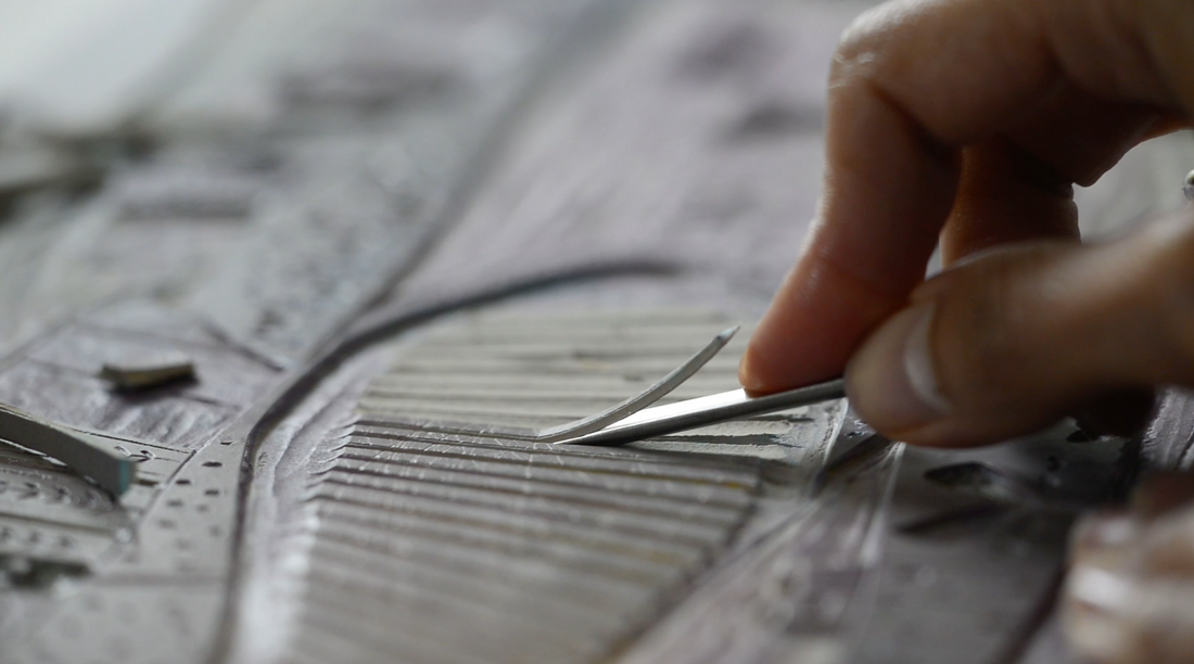 Close-up of Layla Khani carving a lino block for an original reduction linocut print.