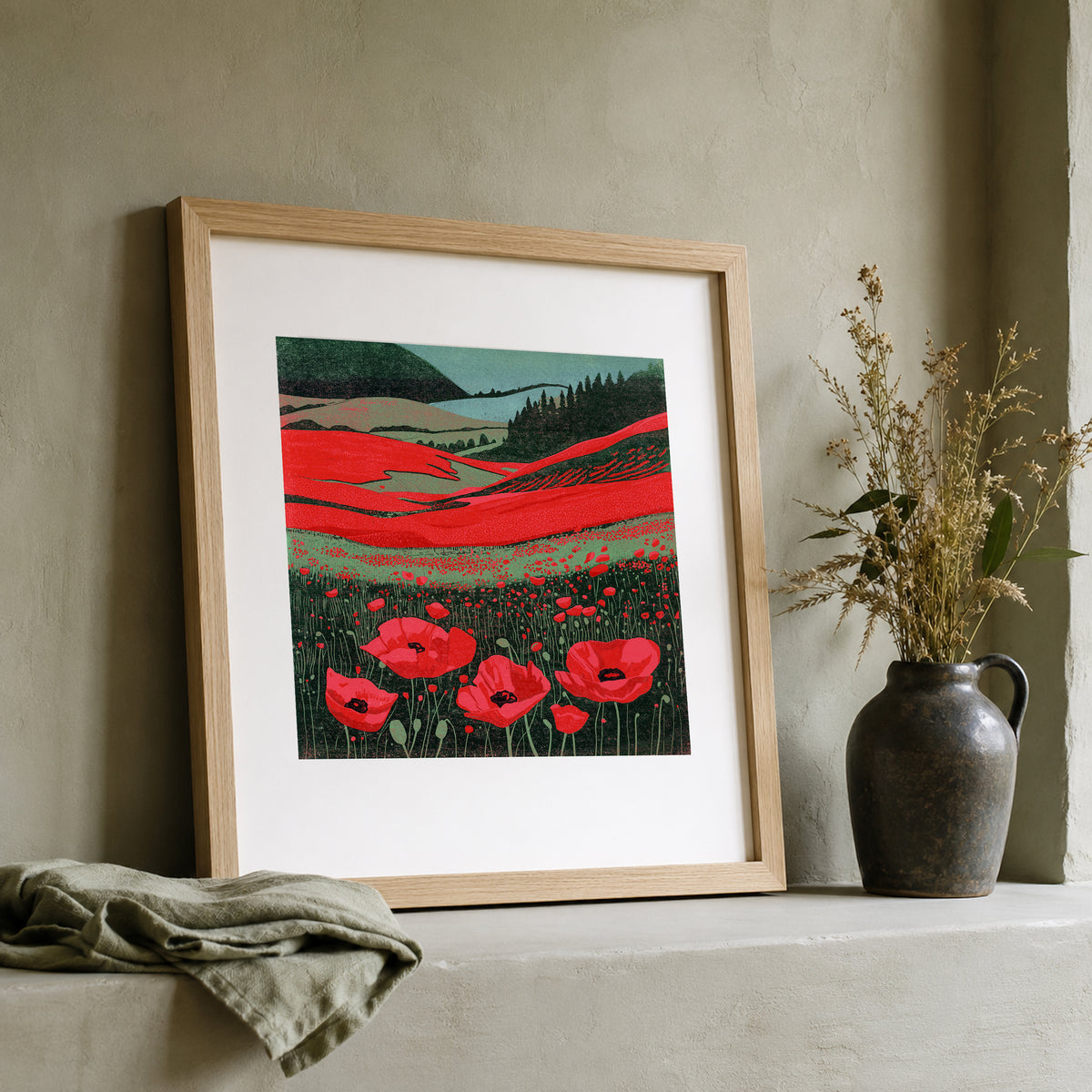 Poppy Fields colourful linocut print framed and leaning on a shelf