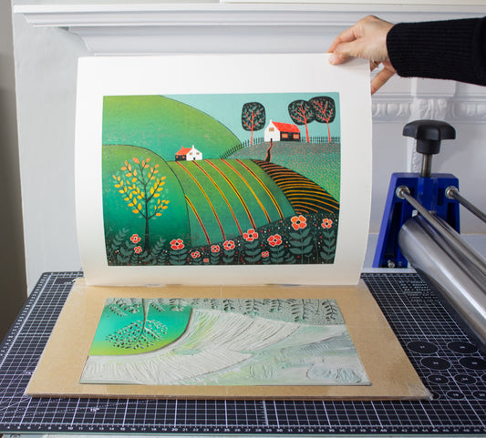 The Path Home linocut print being hand-pulled in the studio by Layla Khani, Laylart Studio