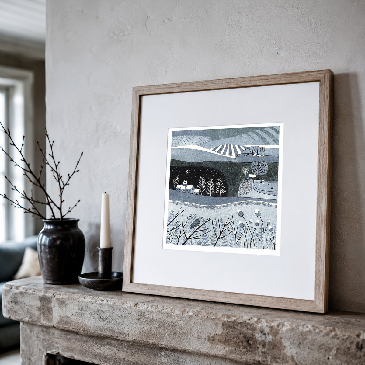 Wild Winter winter landscape linocut print framed and leaning on a shelf

