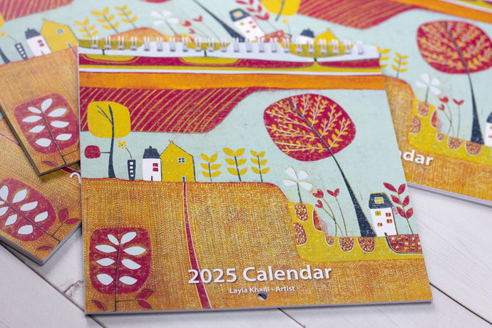 Front cover of the 2025 wall planner displaying a bold linocut design by Layla Khani, highlighting the artistic theme of the calendar.