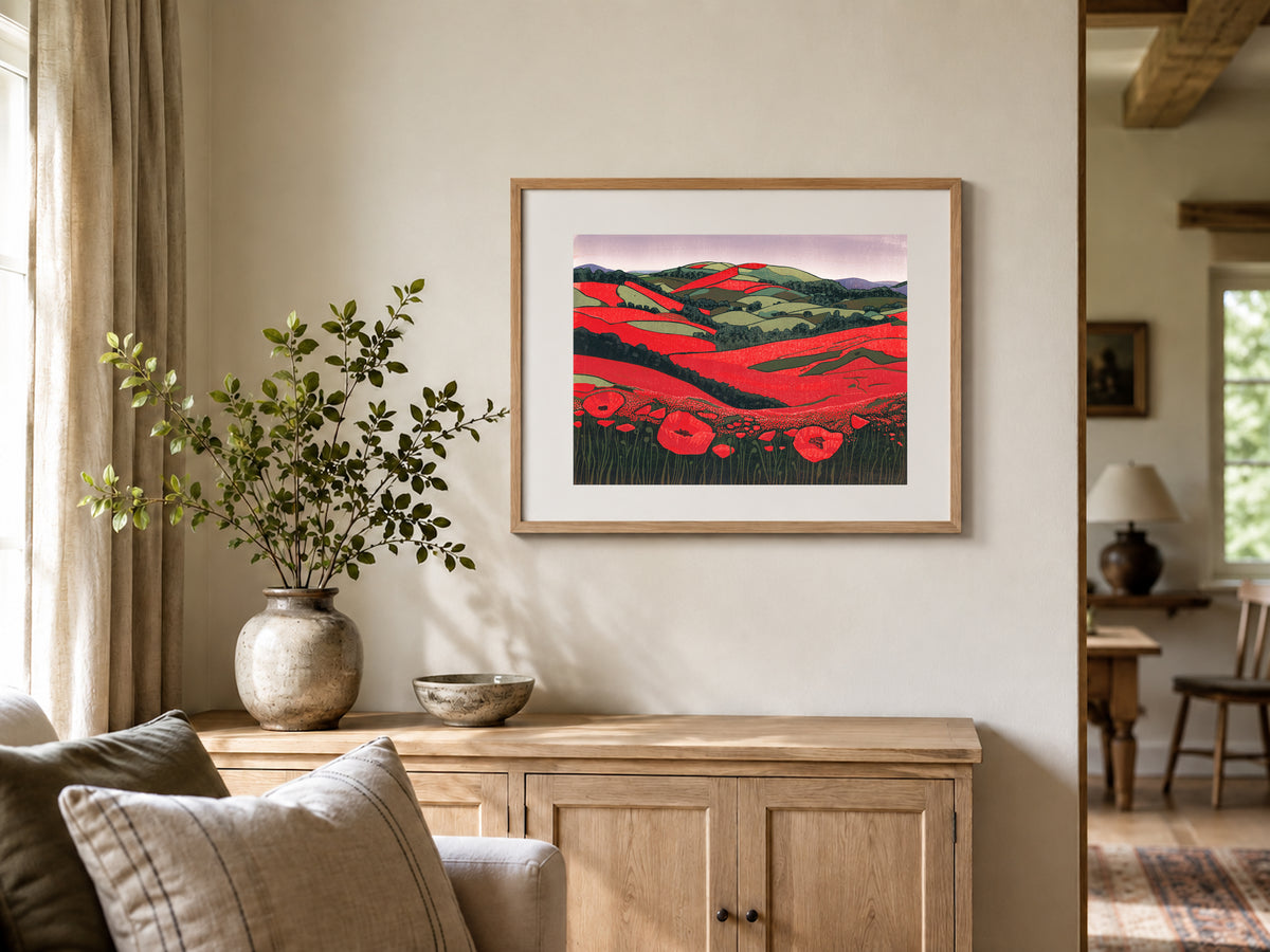 Poppies Unveiled colourful landscape linocut print shown framed on a wall