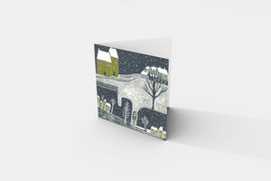 Christmas card from the Wintry Nights Collection, illustrating a peaceful snowy winter night scene with intricate linocut artistry.