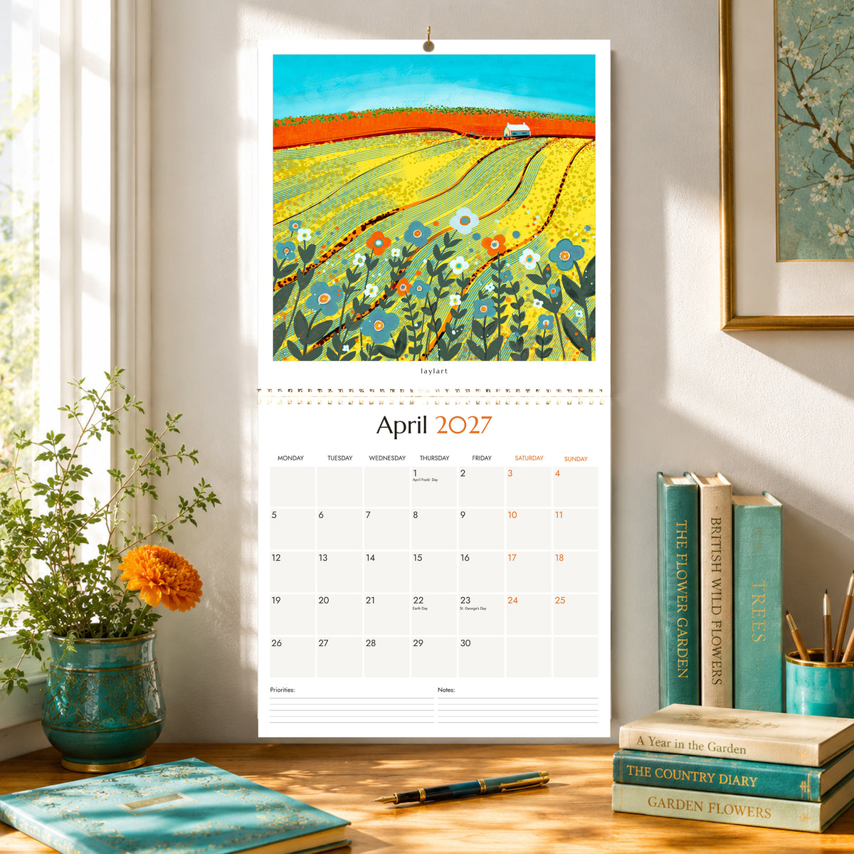2027 square wall calendar open to April with colourful British countryside artwork by Layla Khani