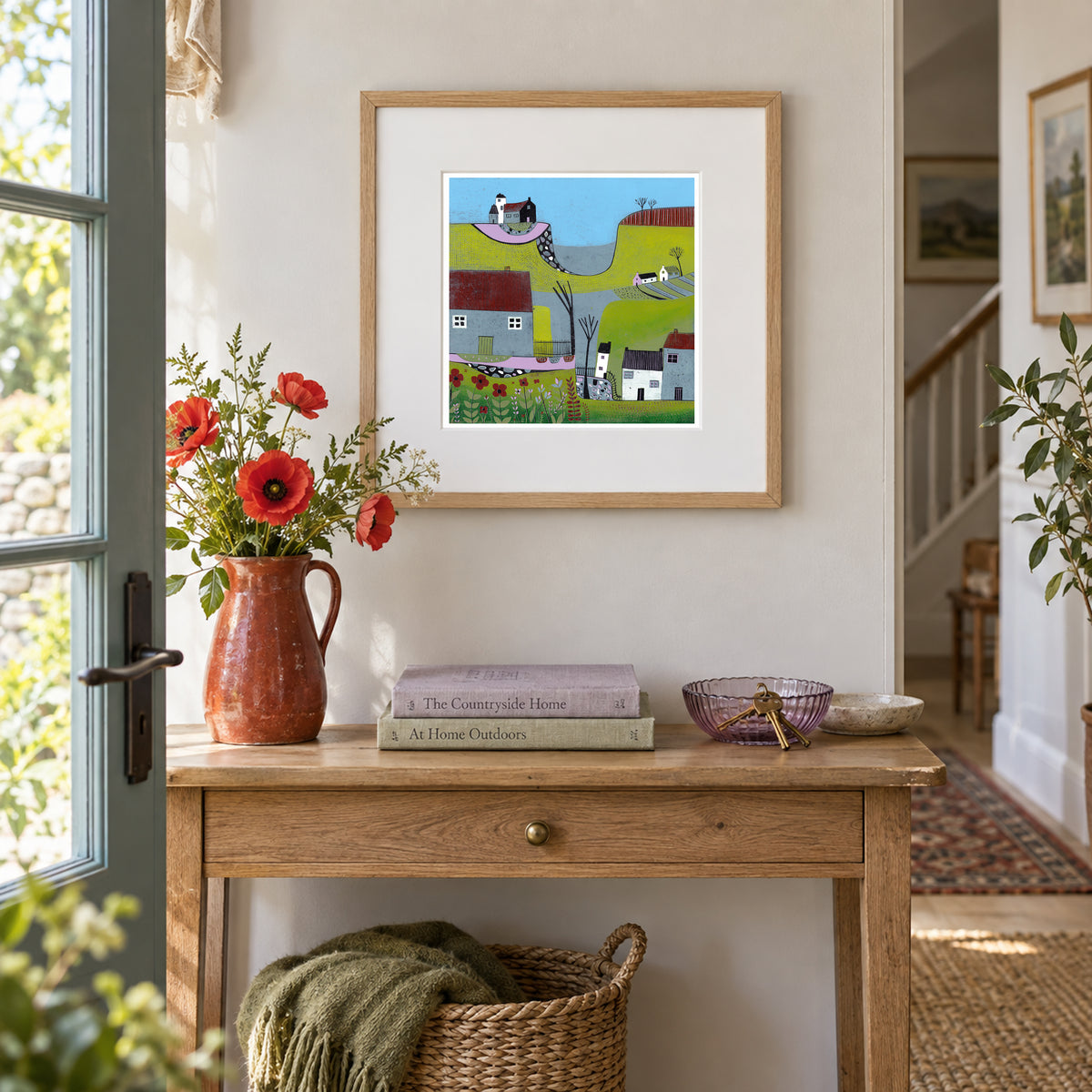 The Hills Above the Shore framed landscape linocut print displayed in a warm contemporary interior