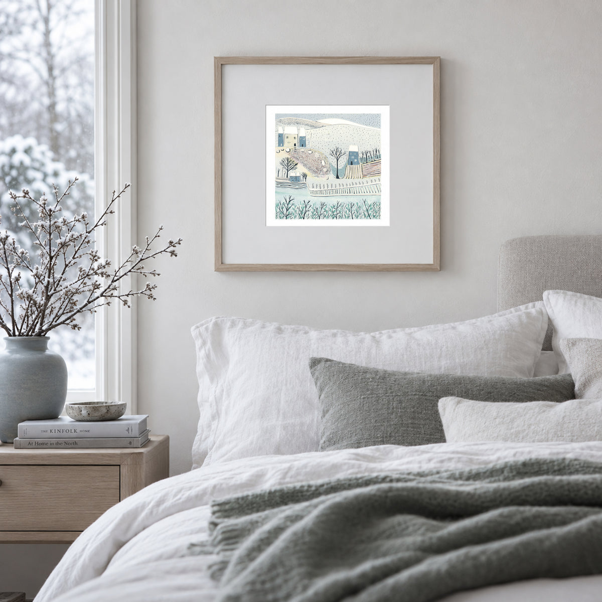Blue Winter framed winter landscape linocut print displayed in a calm bedroom interior