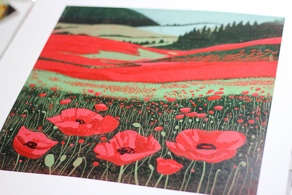 Detail of red poppies and hand-carved textures in Poppy Fields reduction linocut print