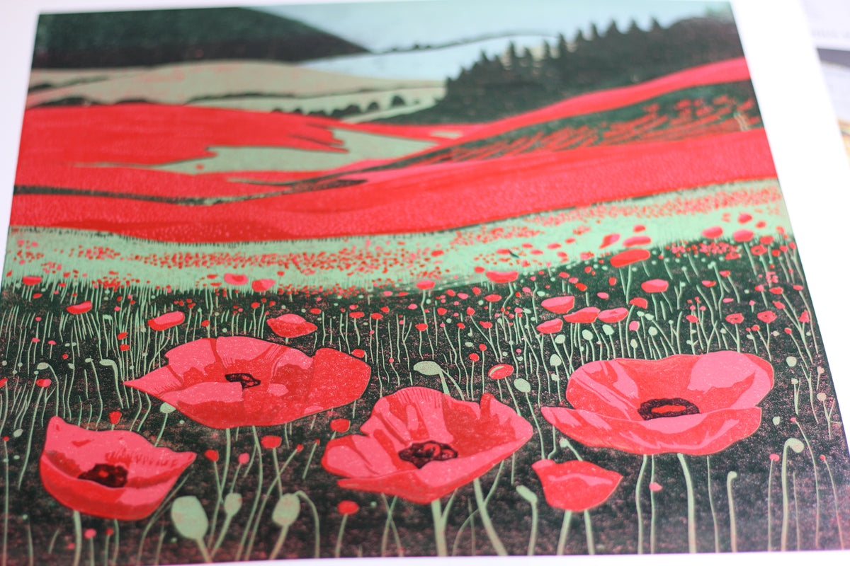 Detail of red poppies and hand-carved textures in Poppy Fields reduction linocut print