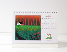 Load image into Gallery viewer, July 2024 page of the Desk Calendar, revealing a stunning linocut print on the left, capturing a vibrant summer landscape, with the right side offering a month-at-a-glance layout featuring dates and days for effortless organisation.