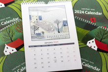 Load image into Gallery viewer, Open view of the 2024 Linocut Wall Calendar, revealing the January 2024 page embellished with a charming winter scene linocut print by Laylart Studio.