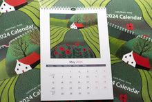 Load image into Gallery viewer, Open view of the May 2024 calendar page, displaying a vibrant linocut print at the top and neatly arranged dates and days at the bottom, providing a glimpse of the calendar&#39;s design.