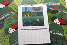 Load image into Gallery viewer, Open view of the Linocut Wall Art Calendar for June 2024, highlighting a captivating linocut print that beautifully encapsulates the month&#39;s unique charm and character.