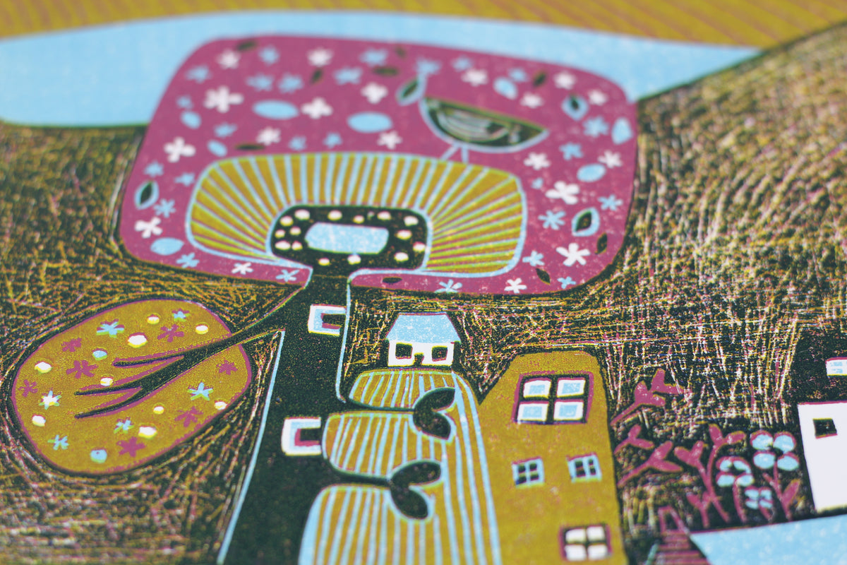 Close-up of carved trees, houses and patterned fields in Over the Mountains linocut print