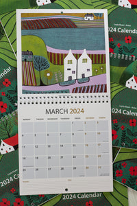 March 2024 calendar page showcasing a vibrant linocut print of a rural landscape, featuring a charming house and colorful scenery
