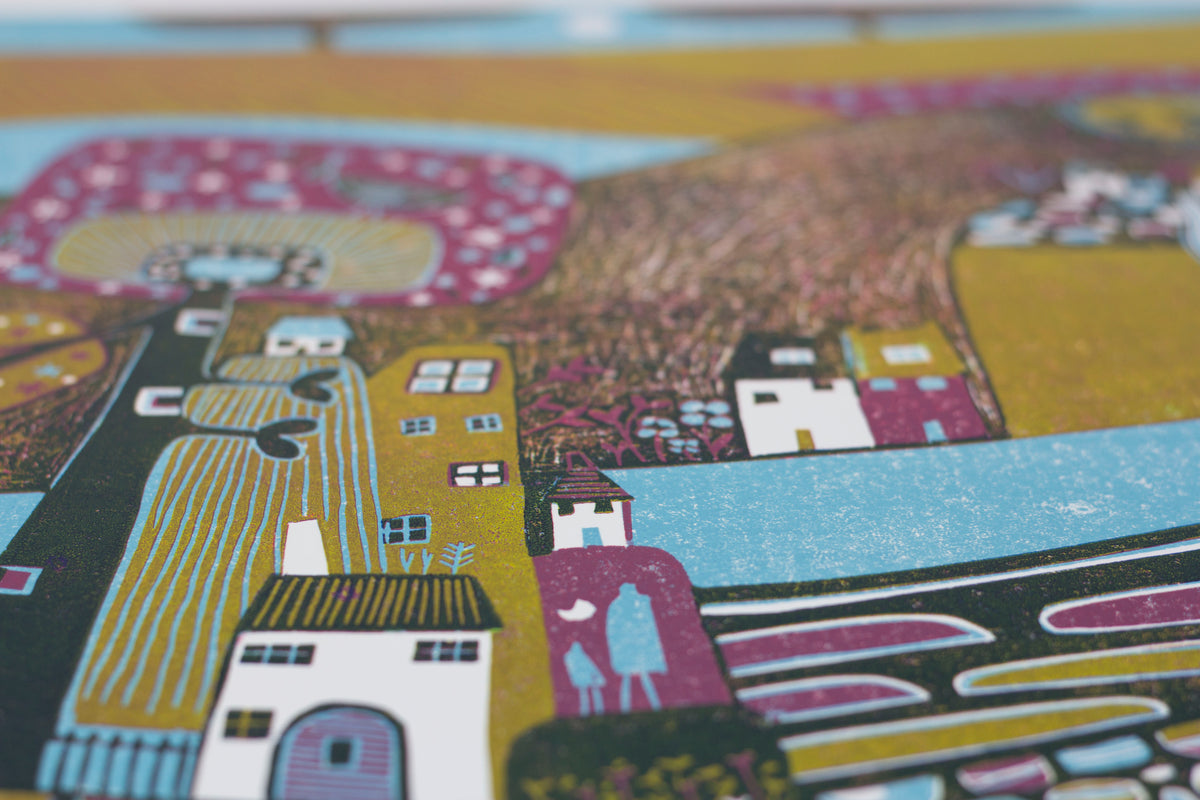 Detail of houses, layered fields and hand-printed textures in Over the Mountains linocut