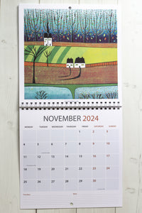 Open view of the 2024 Linocut Wall Calendar, displaying the November page adorned with a captivating autumnal linocut print