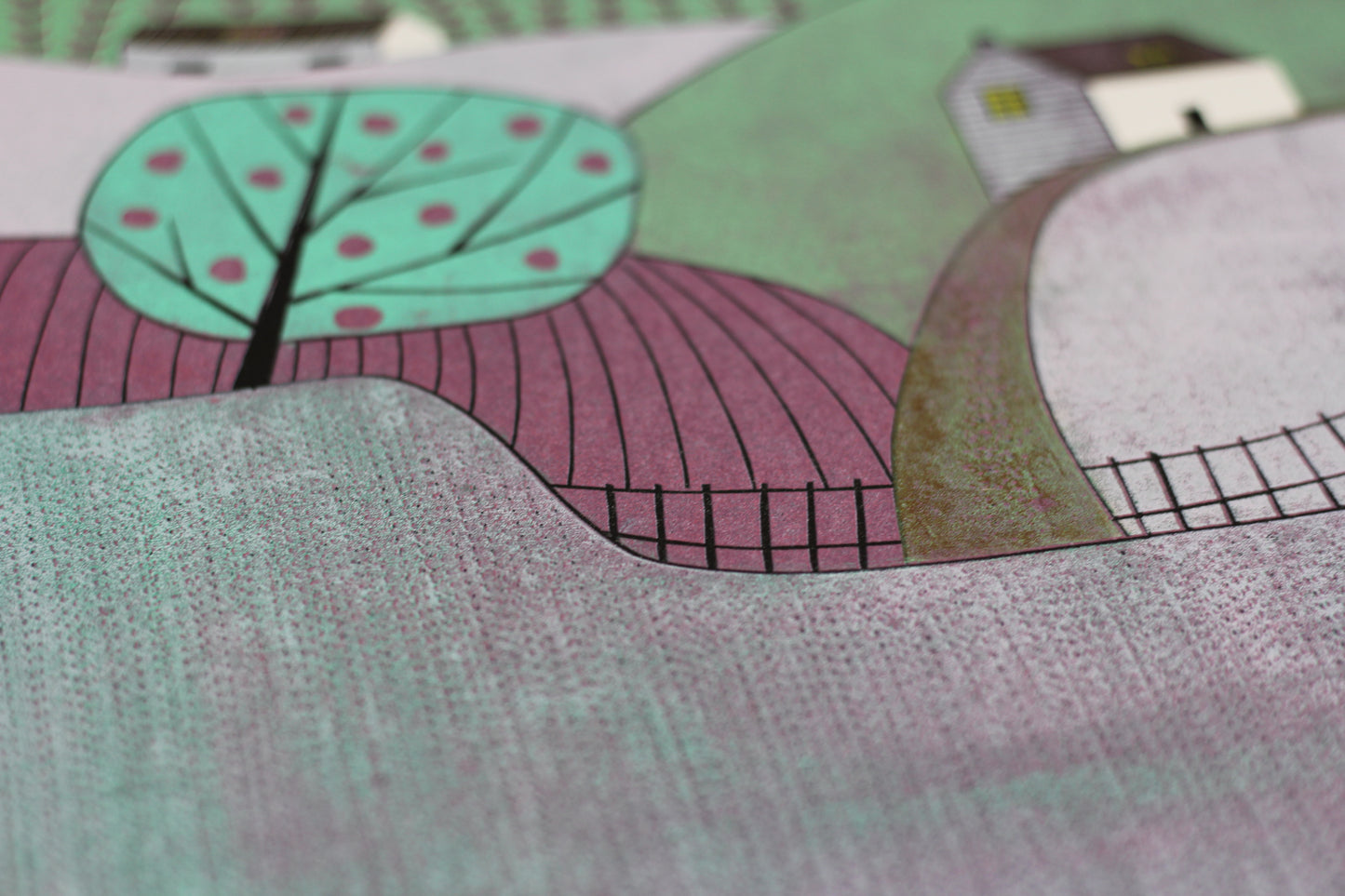Close-up of the hand-printed texture and apple tree detail in the Apple Orchard linocut.