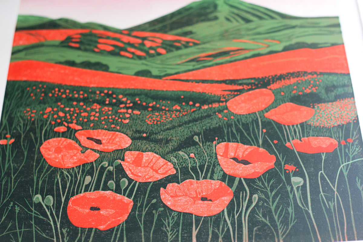 Colourful fields and hillside detail in Hillside Poppies in Bloom reduction linocut