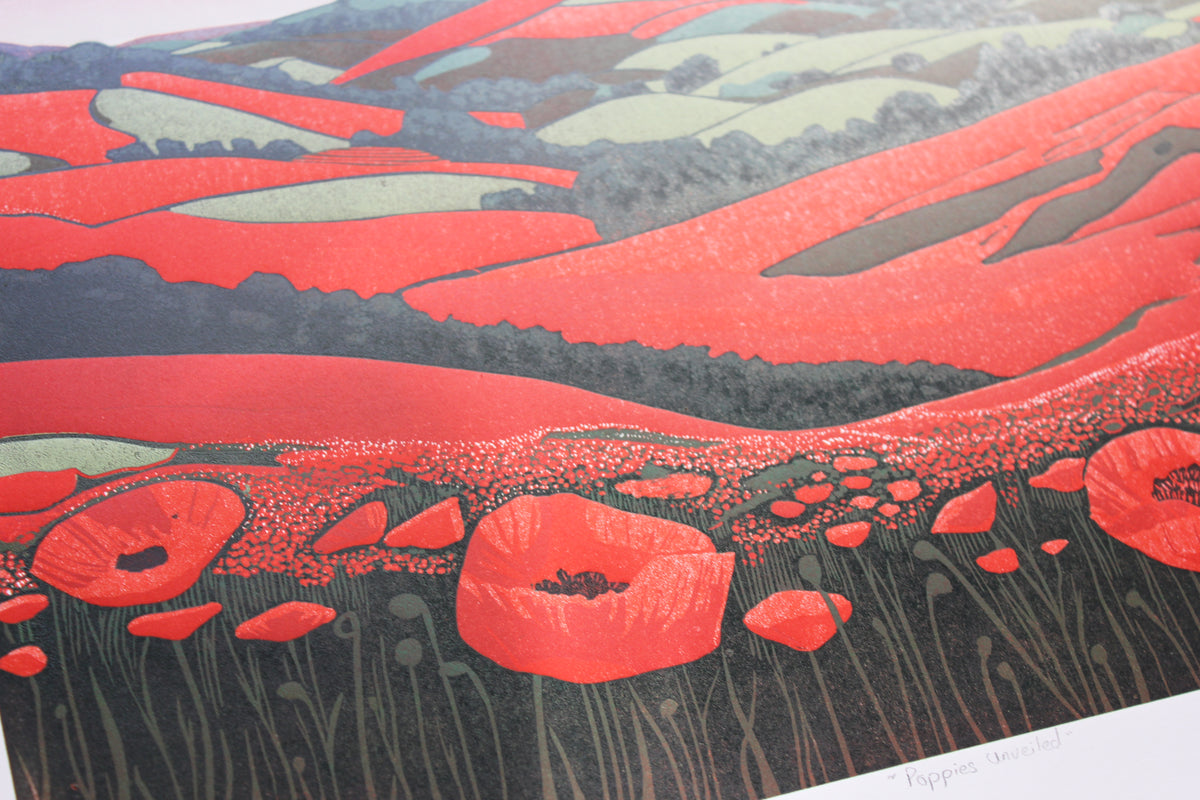 Detail of red poppies, green fields and distant blue hills in an original reduction linocut