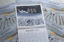 Load image into Gallery viewer, Winter Scene linocut print by Layla Khani from Laylart Studio, featured in a large square wall calendar for January 2025.