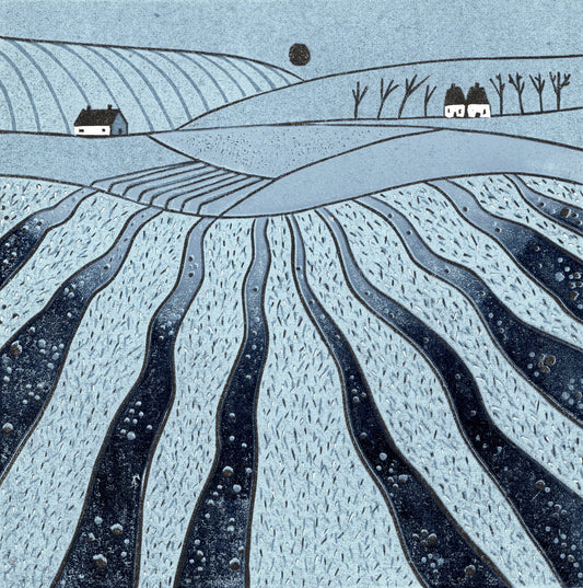 Where the Hills Breathe original blue linocut print featuring sweeping patterned fields, white cottages, bare trees and rolling hills.