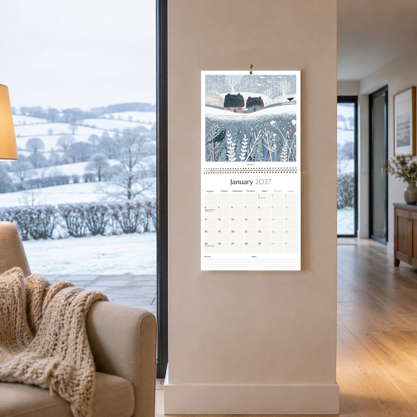 Large square 2027 wall calendar open to January with snowy winter landscape artwork