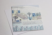 Load image into Gallery viewer, Christmas card from the Wintry Wonders Collection, featuring a subtle snowy scene in shades of blue, gray, and white. The linocut print portrays a gentle snowfall, ideal for holiday cheer.