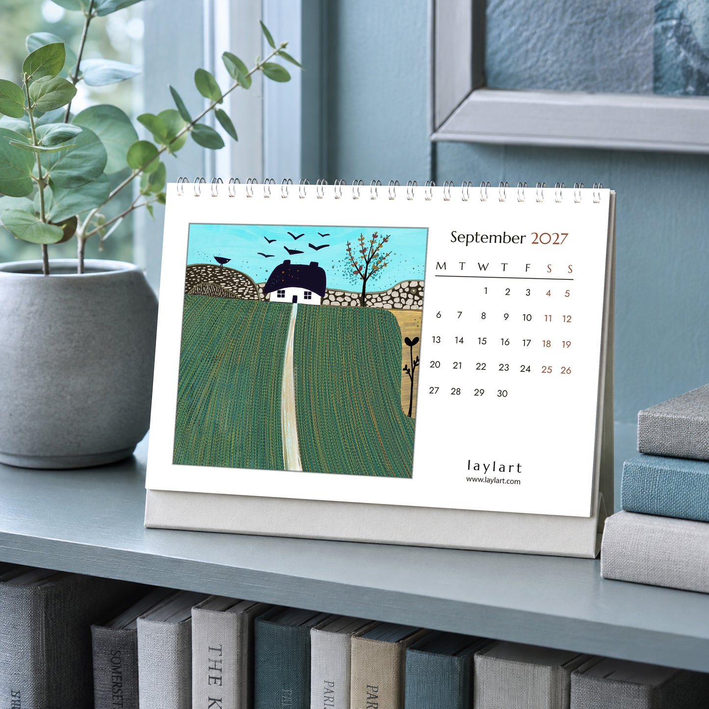 2027 desk calendar open to September with green countryside landscape painting