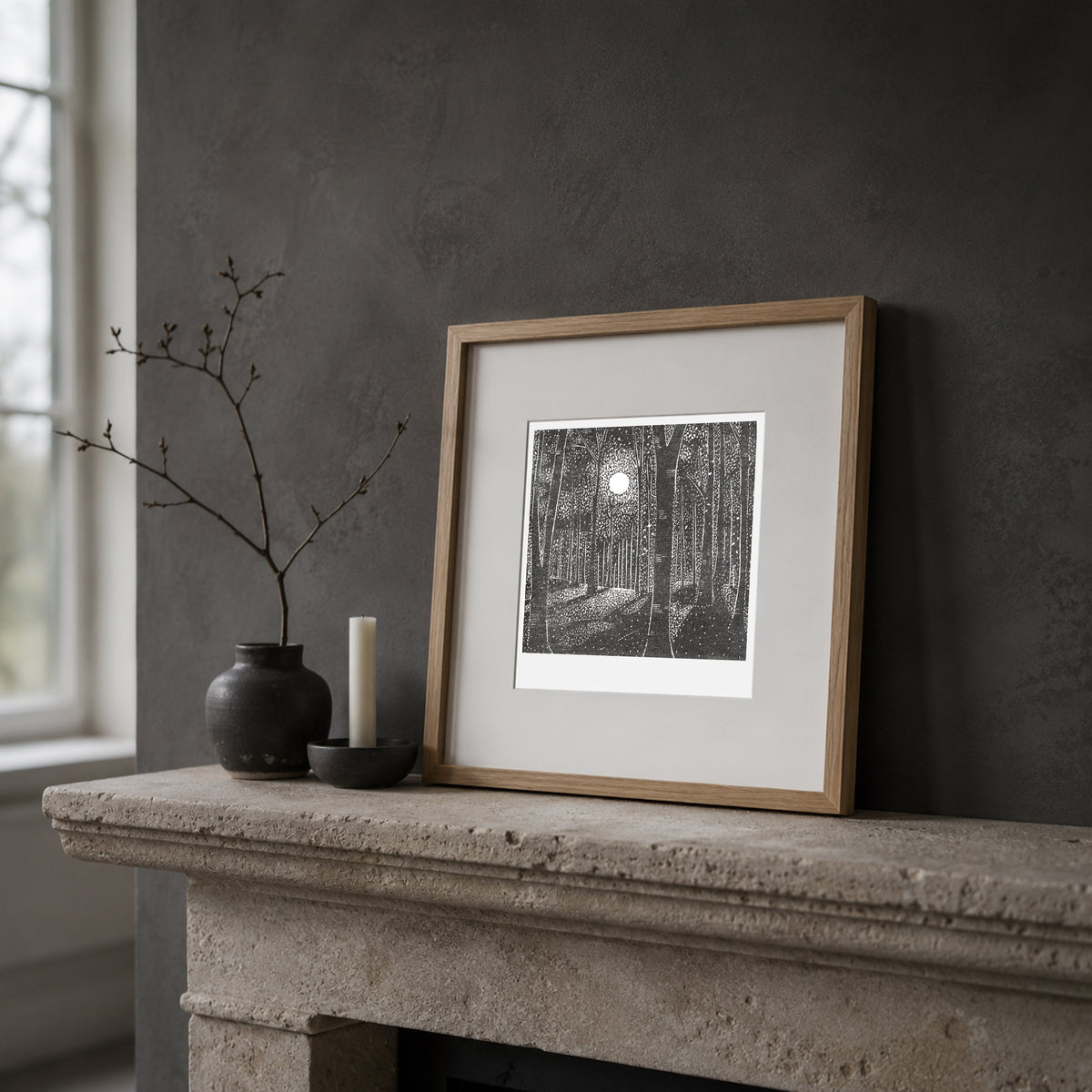 Whispers of Moonlight black and white woodland linocut print framed on a mantel
