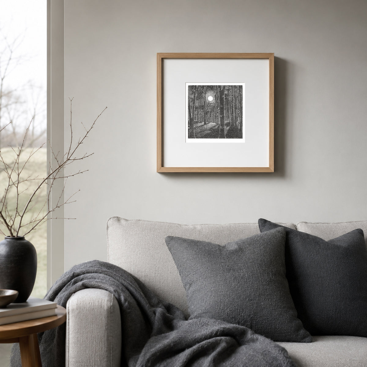 Whispers of Moonlight original woodland linocut print framed and displayed above a sofa
