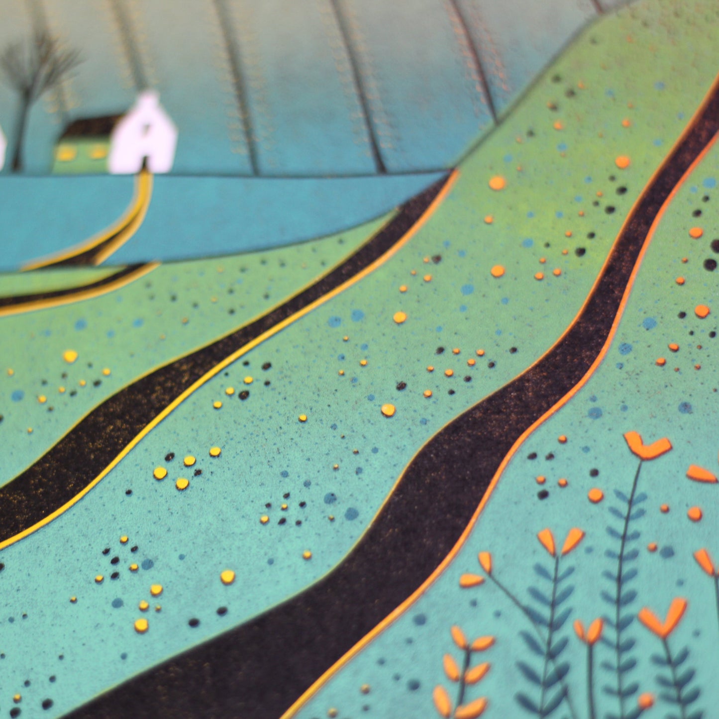 Close-up of the linocut showing the textured green furrows and hand-printed red poppies and cottage roofs.
